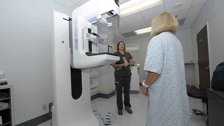 Mammogram technician with a patient