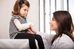 Female nurse with a pediatric patient