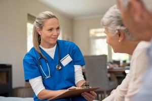 Senior nurse speaking with patients