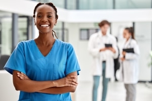 Beautiful African-American nurse in blue scrubs