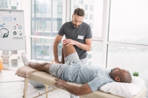 Physical therapy professional examining a patient