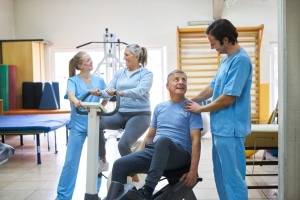 Older patients performing exercises at a physical therapy clinic