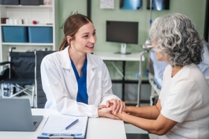 Beautiful medical professional speaking with an older patient